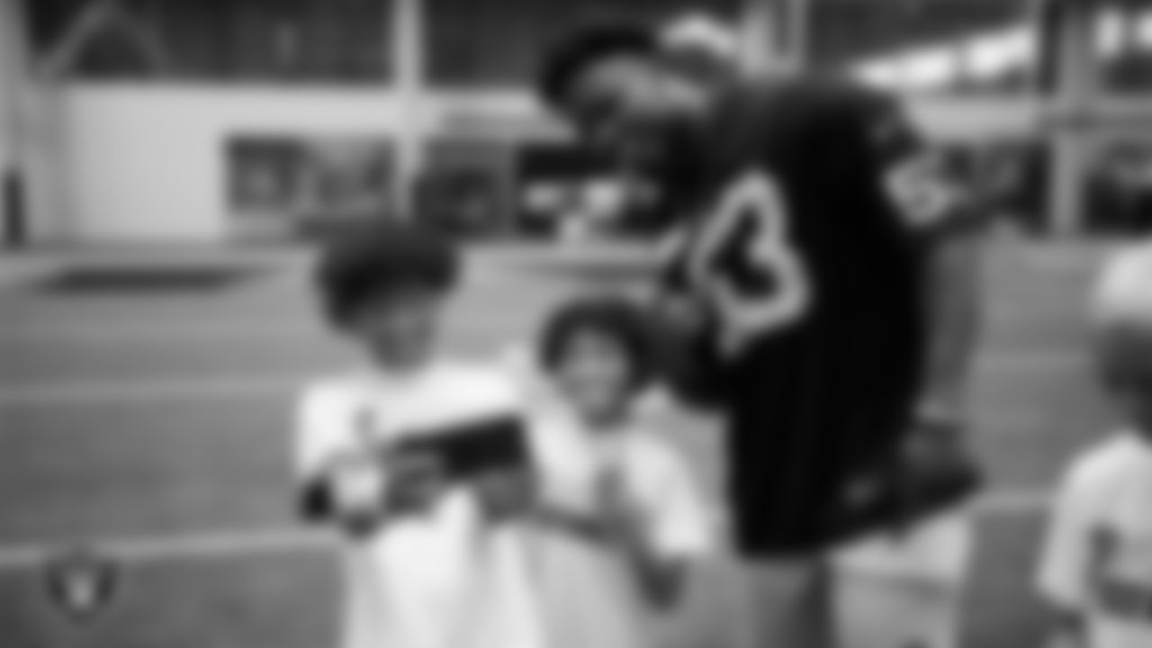Las Vegas Raiders linebacker Amari Gainer (53) poses for a selfie with athletes at a skills camp during Play Football Day at Intermountain Health Performance Center.