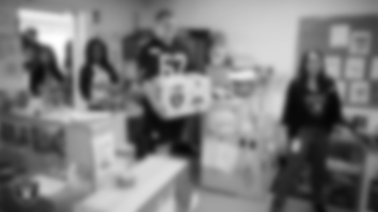 Las Vegas Raiders center Will Putnam (67) delivers a classroom gift box to celebrate Teacher Appreciation Week at Matt Kelly Elementary School.