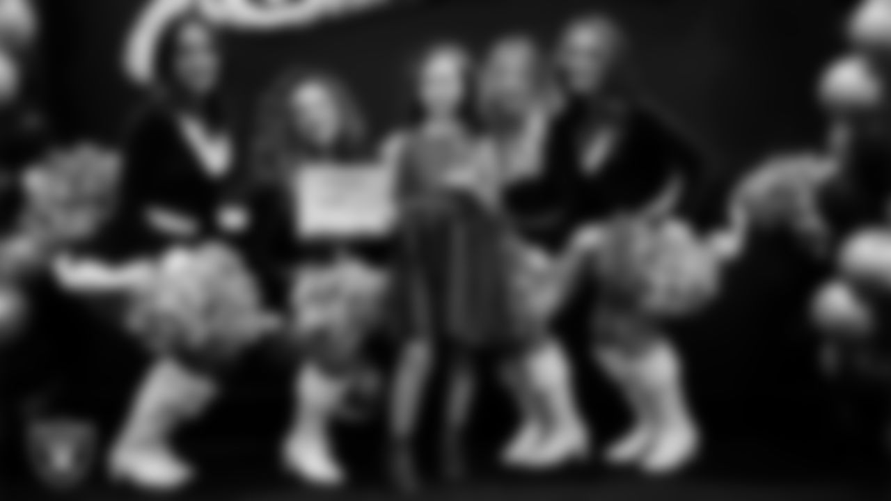 Raiderettes pose for a photo with a Junior Raiderette during the Junior Raiderettes Banquet at The Studio.