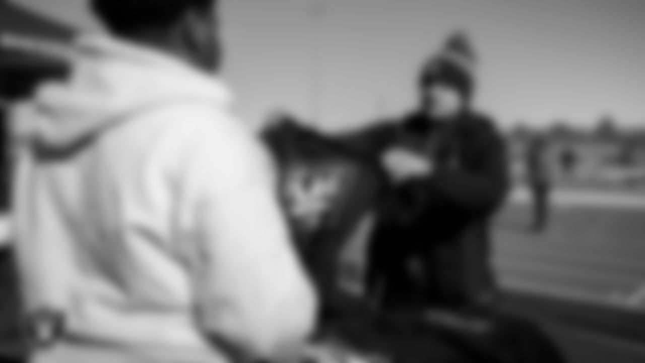 An attendee receives Las Vegas Raiders gear during Silver and Black Saturday at Liberty High School.