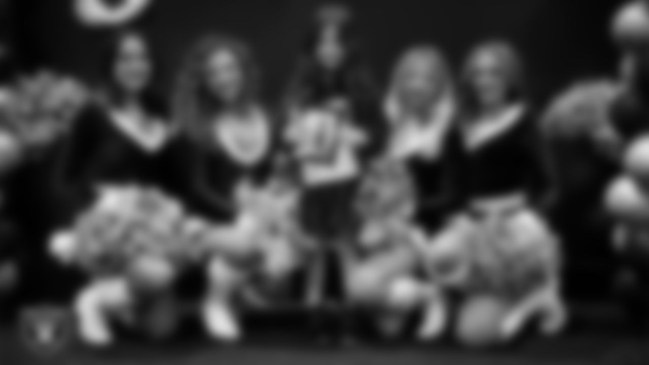 Raiderettes pose for a photo with a Junior Raiderette during the Junior Raiderettes Banquet at The Studio.