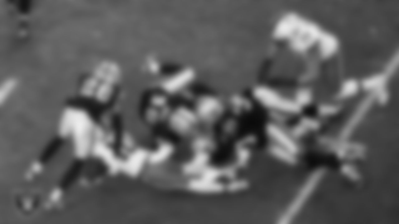 Las Vegas Raiders cornerback Darien Porter (26), linebacker Devin White (45), cornerback Darnay Holmes (30) and safety Isaiah Pola-Mao (20) go to make a tackle during the regular season home game against the Cleveland Browns at Allegiant Stadium.