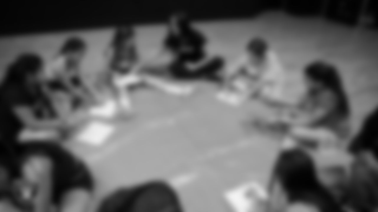 Raiderette Amanda works on a painting with dancers during day one of summer camp at The Studio.