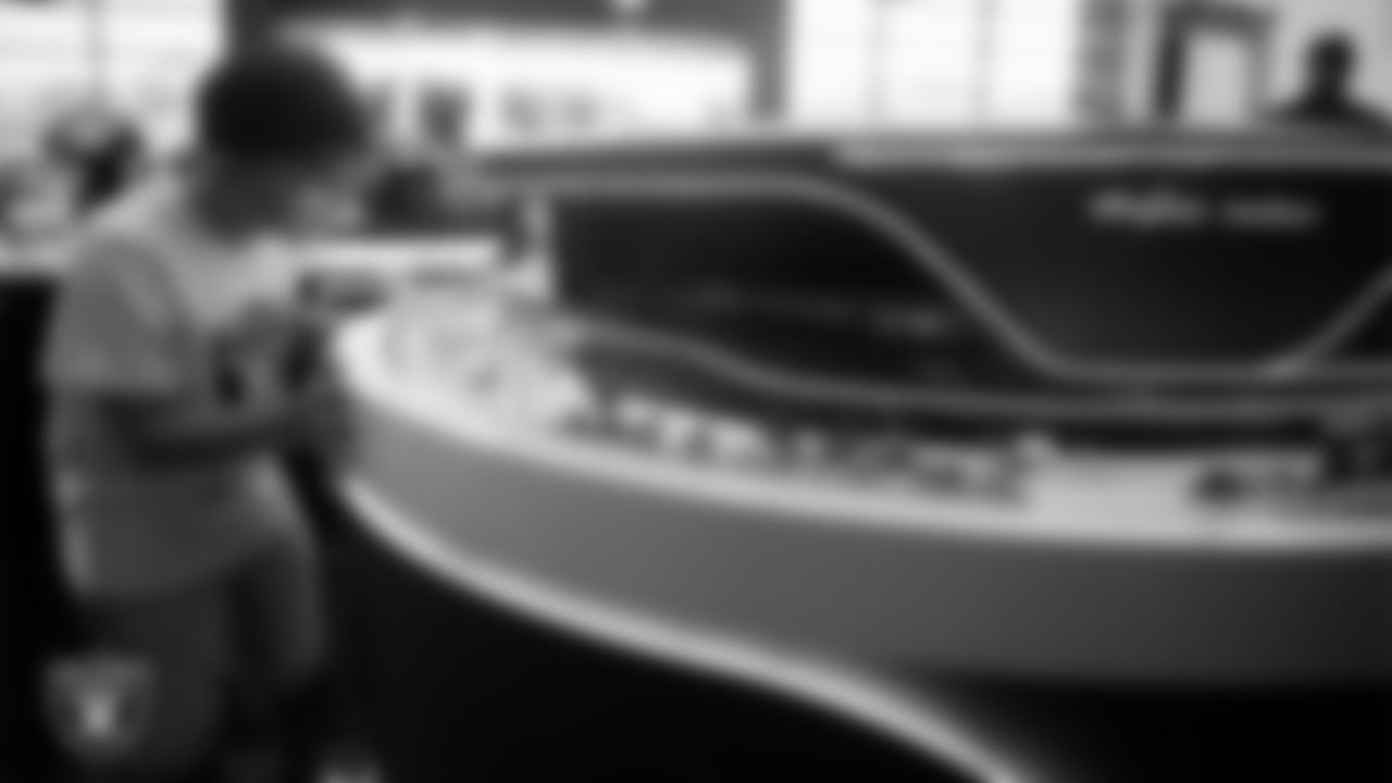 Christopher Arias from Make-A-Wish looks at the Allegiant Stadium model during a visit to Intermountain Health Performance Center.