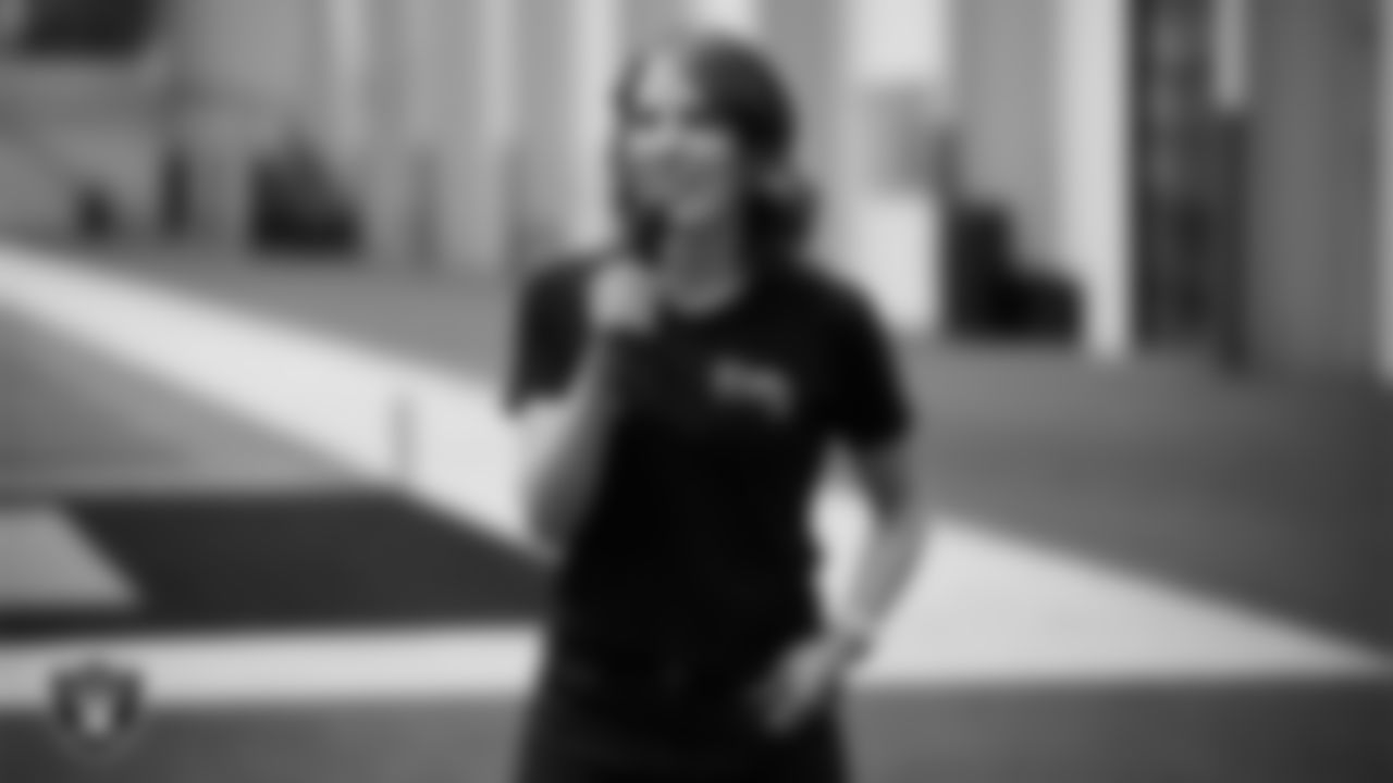 Three Square President and Chief Executive Officer Beth Martino speaks to volunteers before the Raiders Holiday Meal Packing Party at Intermountain Health Performance Center.