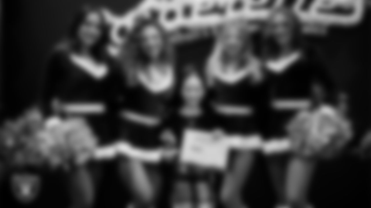 Raiderettes pose for a photo with a Junior Raiderette during the Junior Raiderettes Banquet at The Studio.