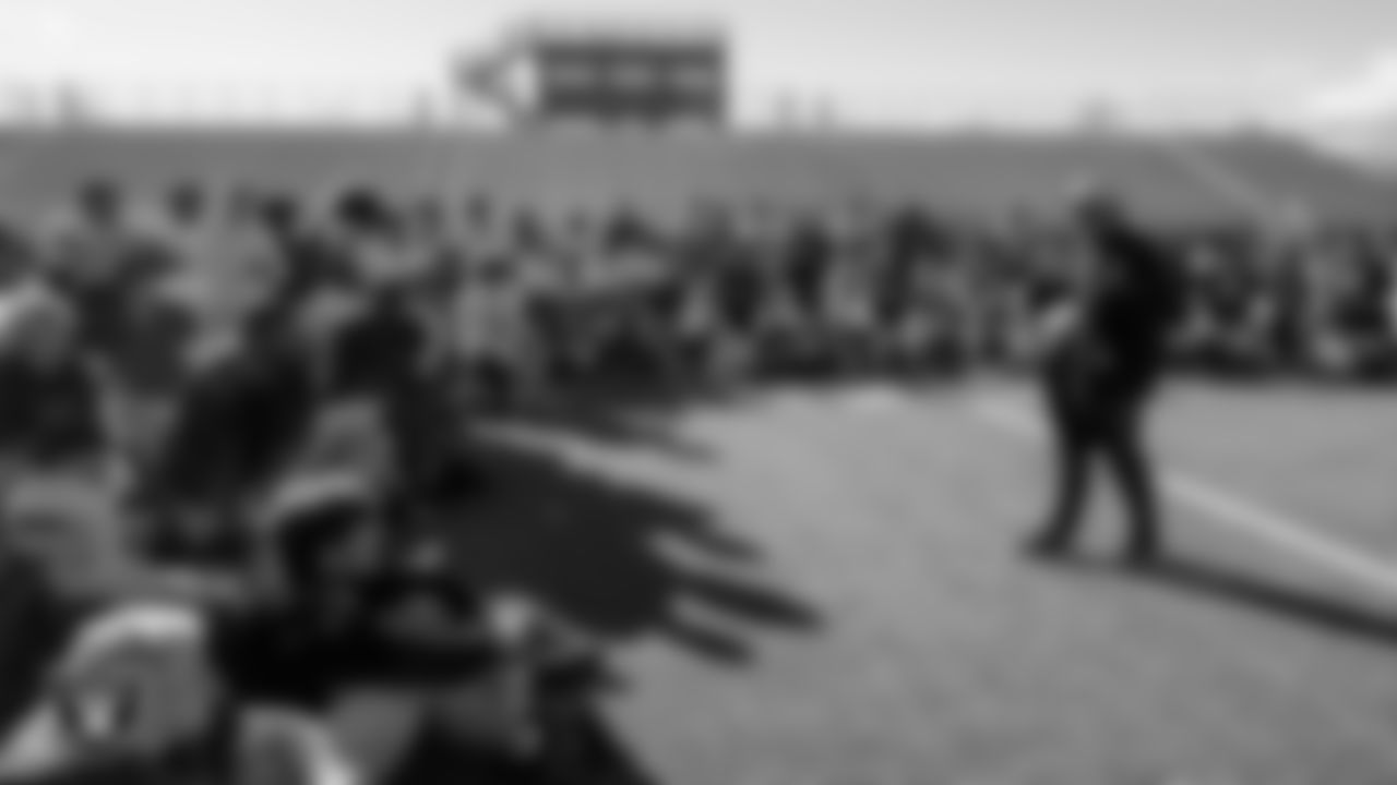 Las Vegas Raiders senior manager of football development Jordan Aguilar hands out High School Showcase t-shirts to the Desert Oasis High School football team during practice at Desert Oasis High School.