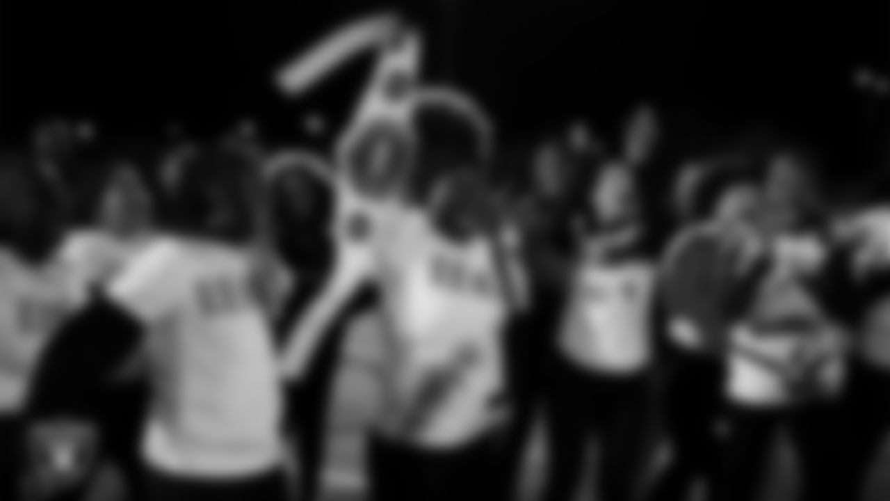 The Democracy Preparatory Academy at Agassi Campus flag football team celebrates with the championship belt after the Raiders' High School Flag Football Showcase game at Doral Academy Red Rock.