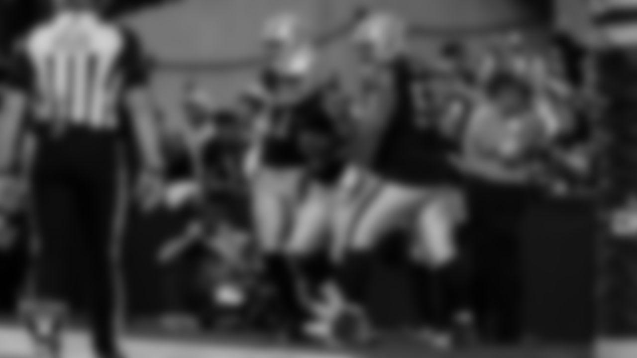 Las Vegas Raiders wide receiver Tyler Lockett (17) celebrates with teammates after making a 4-yard touchdown catch during the regular season home game against the New York Giants at Allegiant Stadium.