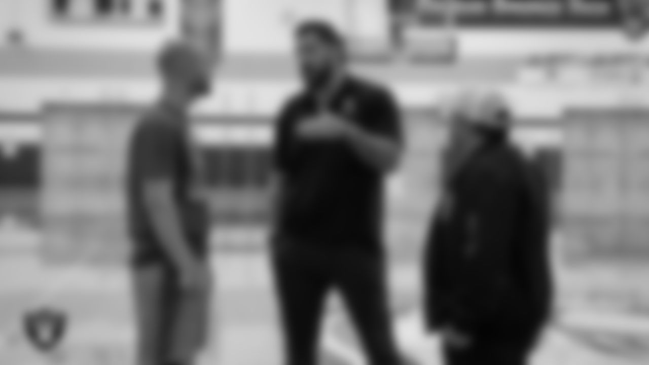 Las Vegas Raiders alumnus Robert Gallery and senior manager of football development Jordan Aguilar speak with Spanish Springs High School football coach Rob Hummel after naming him the Tom Flores Coach of the Year at Spanish Springs High School.
