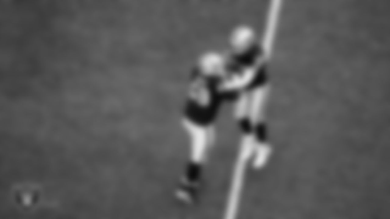 Las Vegas Raiders defensive end Maxx Crosby (98) celebrates with defensive tackle Adam Butler (69) after breaking up a pass during the regular season home game against the Chicago Bears at Allegiant Stadium.
