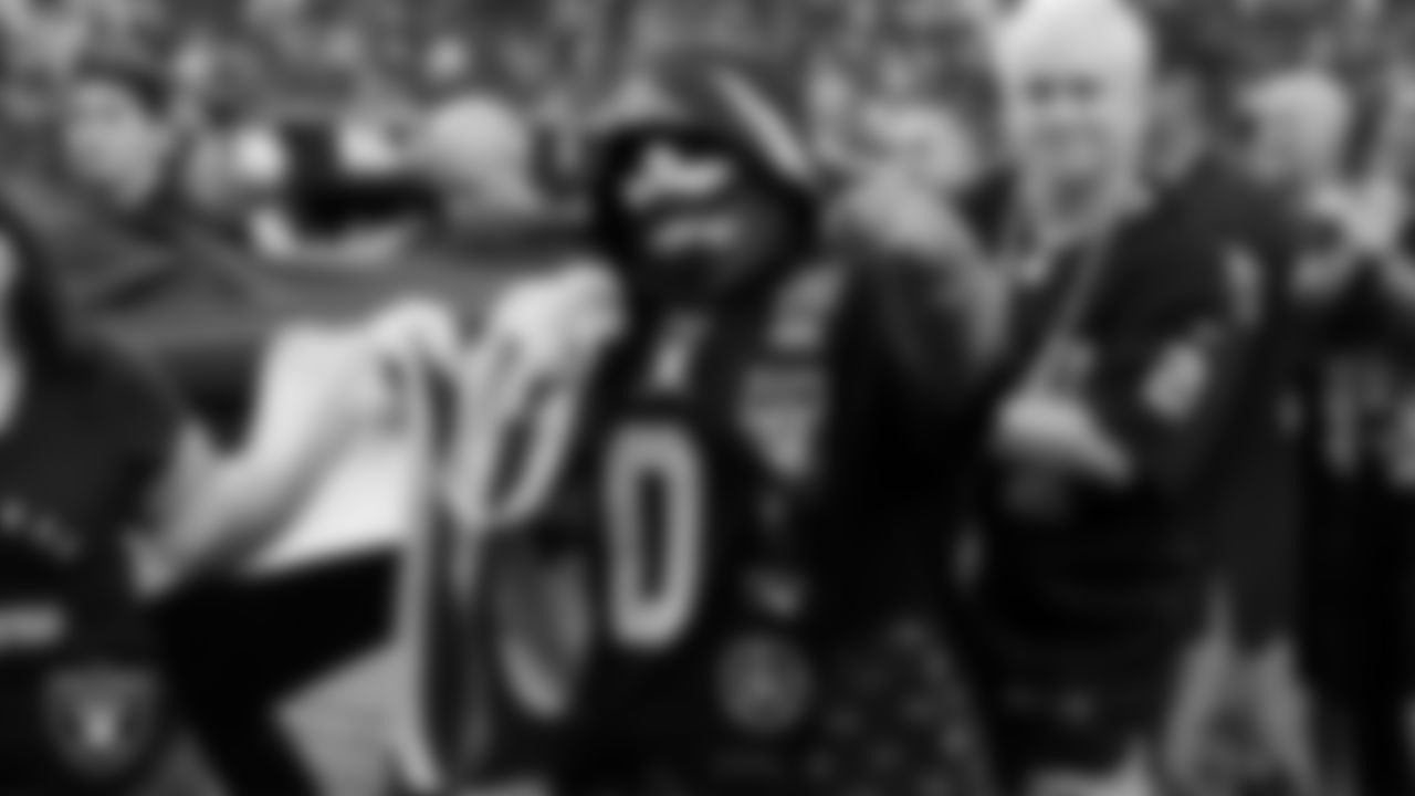 The American flag is displayed by Personal Seat License (PSL) holders on the field during the national anthem before the Las Vegas Raiders' regular season home game against the Tennessee Titans at Allegiant Stadium.
