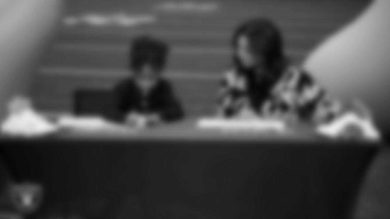 Las Vegas Raiders President Sandra Douglass Morgan designs custom shoes for My Cause My Cleats with Intermountain Children's Health patient Evelyn at Intermountain Health Performance Center.