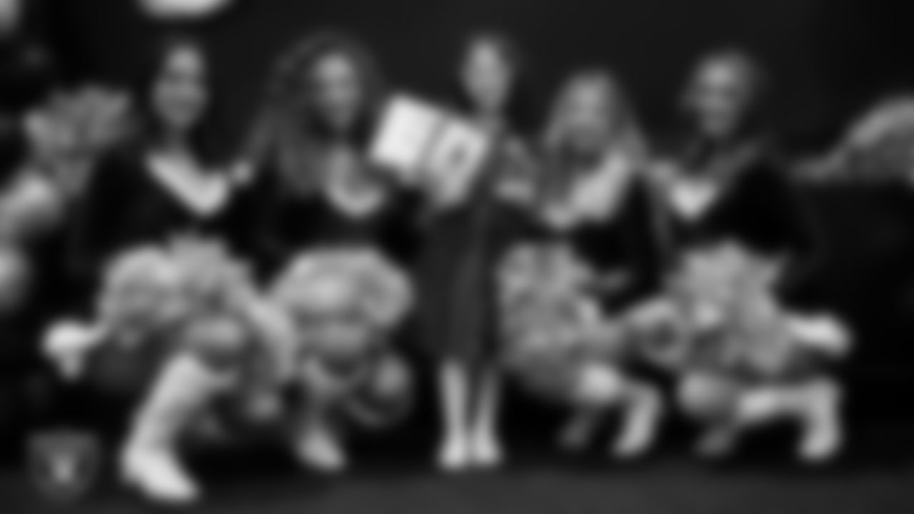 Raiderettes pose for a photo with a Junior Raiderette during the Junior Raiderettes Banquet at The Studio.