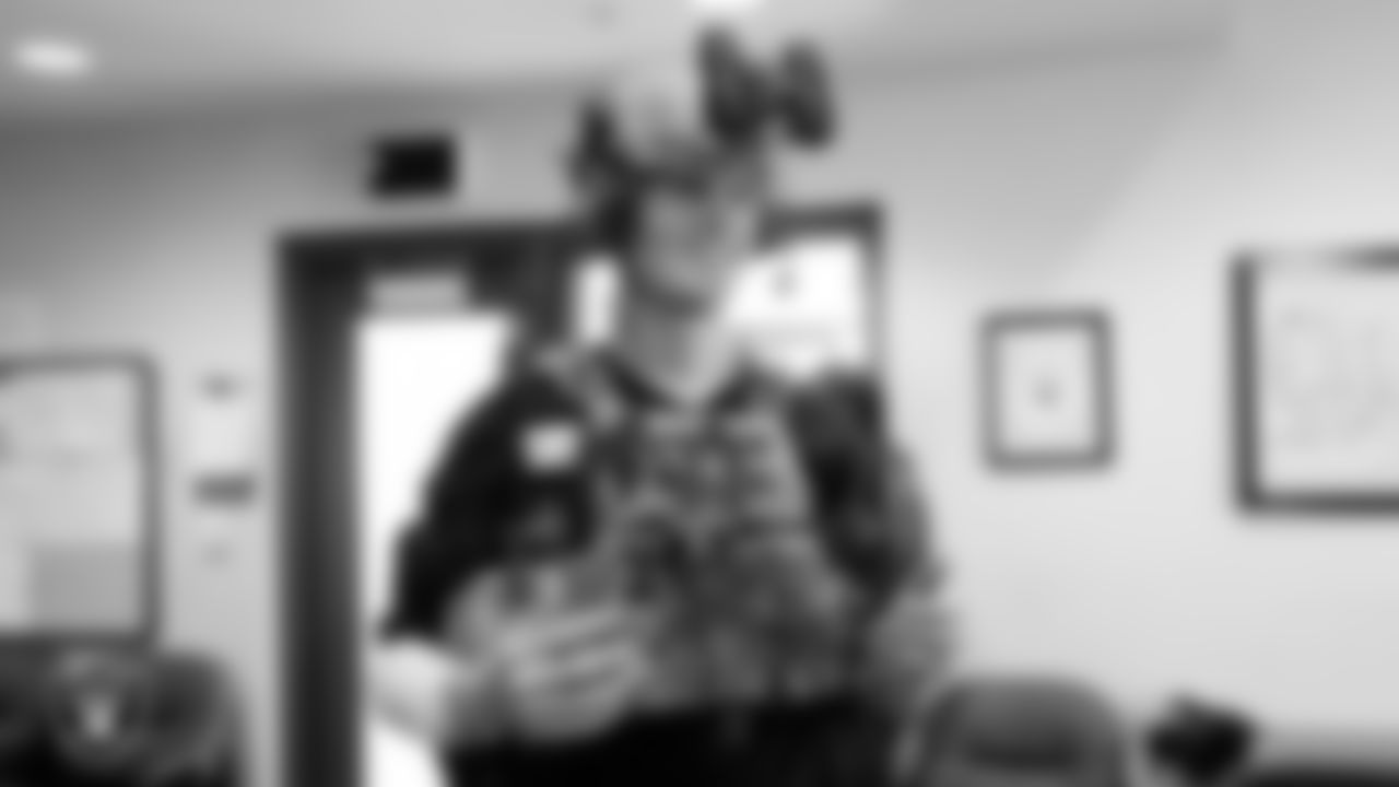 Las Vegas Raiders kicker Daniel Carlson (8) tries on military equipment during a tour of Nellis Air Force Base.