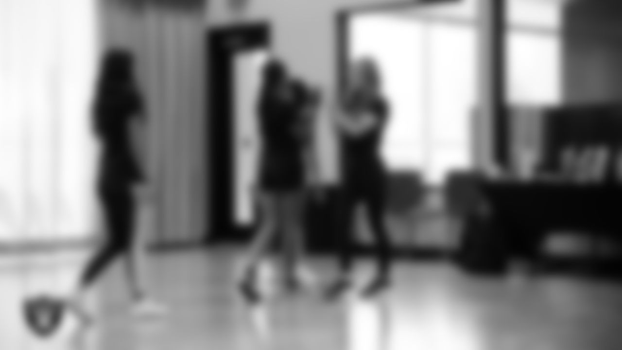 Raiderette Audrey high-fives dancers after their performance during a teen intensive at The Studio.