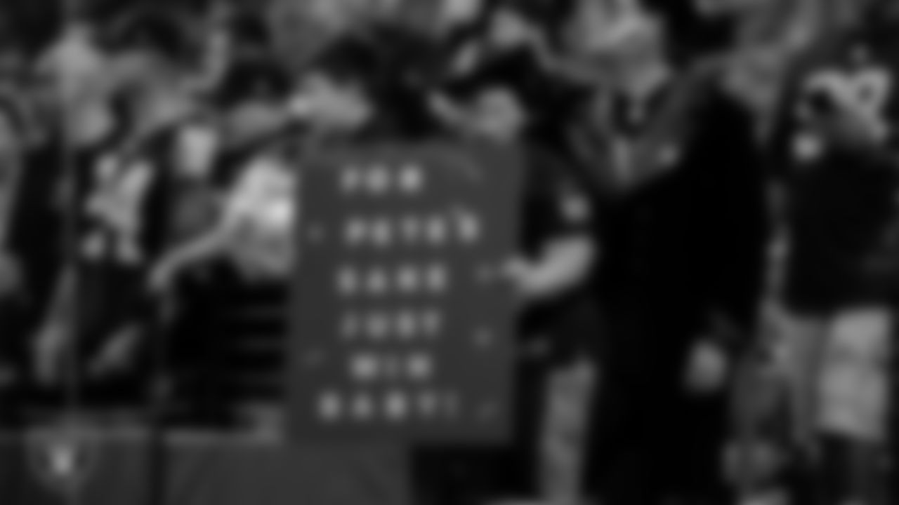 Las Vegas Raiders fans with signs before the regular season home game against the Los Angeles Chargers at Allegiant Stadium.