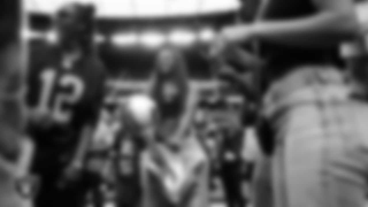Las Vegas Aces guard Jack Young with the Commissioner's Cup Trophy before the Las Vegas Raiders' regular season home game against the Tennessee Titans at Allegiant Stadium.