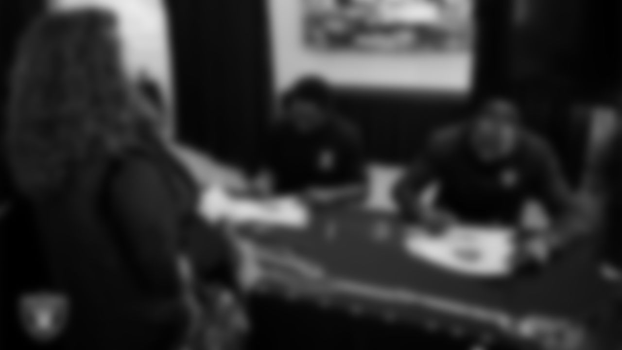 Las Vegas Raiders alumni Cory Littleton and Darren McFadden sign autographs for a service members at Nellis Air Force Base.