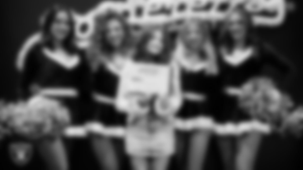 Raiderettes pose for a photo with a Junior Raiderette during the Junior Raiderettes Banquet at The Studio.