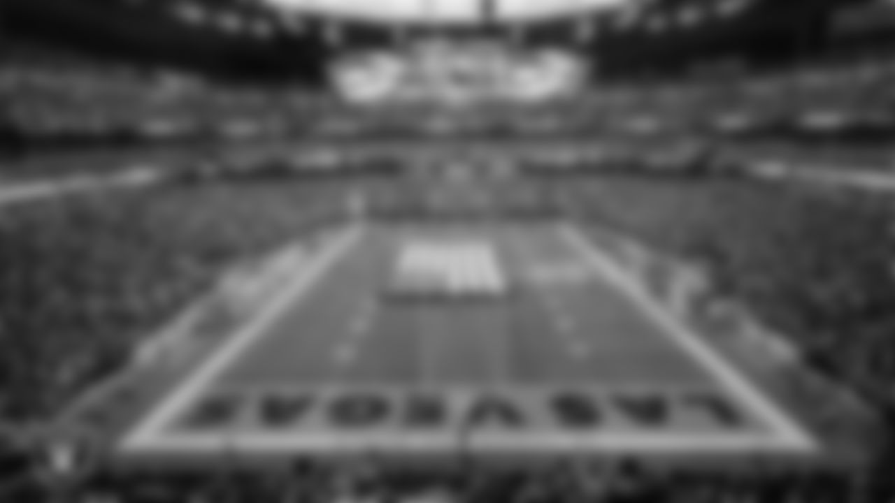 The American flag is displayed by Personal Seat License (PSL) holders on the field during the national anthem before the Las Vegas Raiders' regular season home game against the New York Giants at Allegiant Stadium.