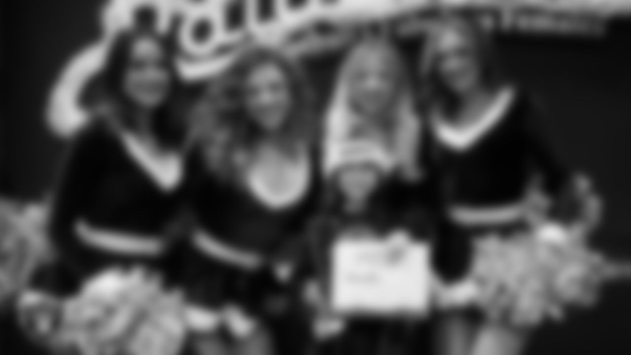 Raiderettes pose for a photo with a Junior Raiderette during the Junior Raiderettes Banquet at The Studio.