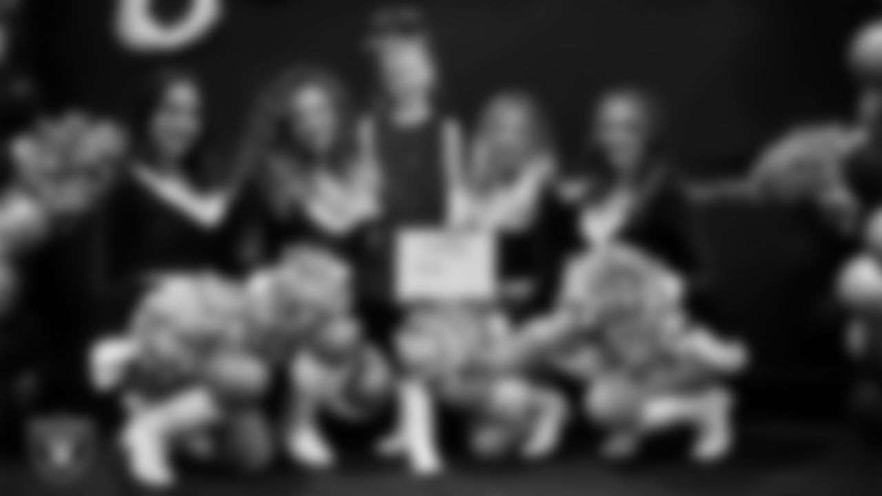 Raiderettes pose for a photo with a Junior Raiderette during the Junior Raiderettes Banquet at The Studio.