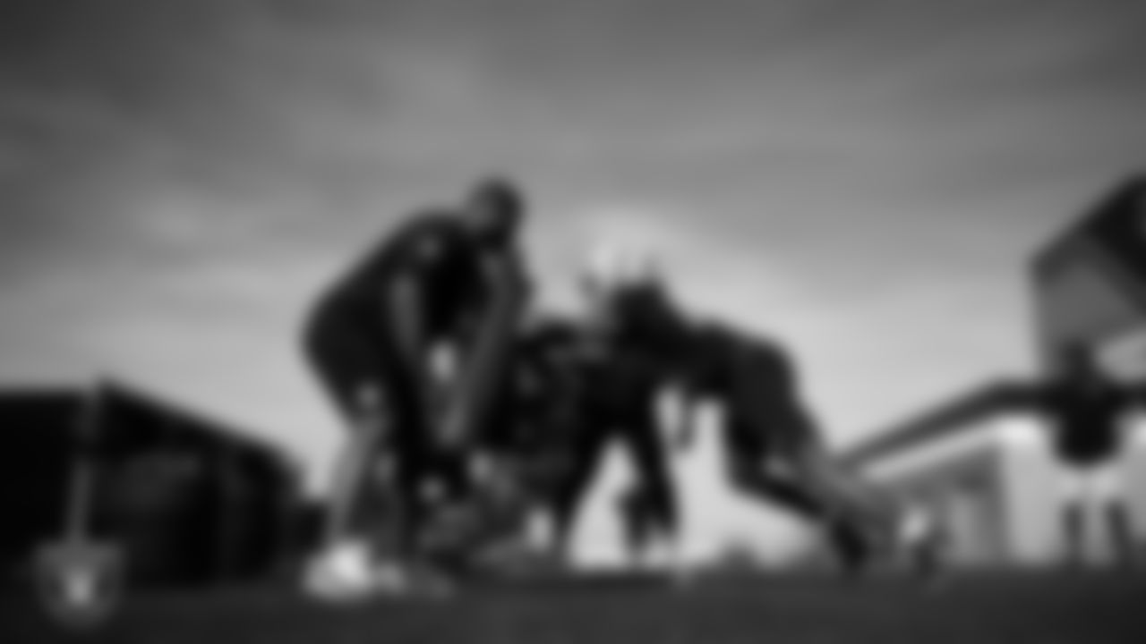 Las Vegas Raiders assistant defensive line coach Kenyon Jackson and defensive tackle Adam Butler (69) during practice at Intermountain Health Performance Center.