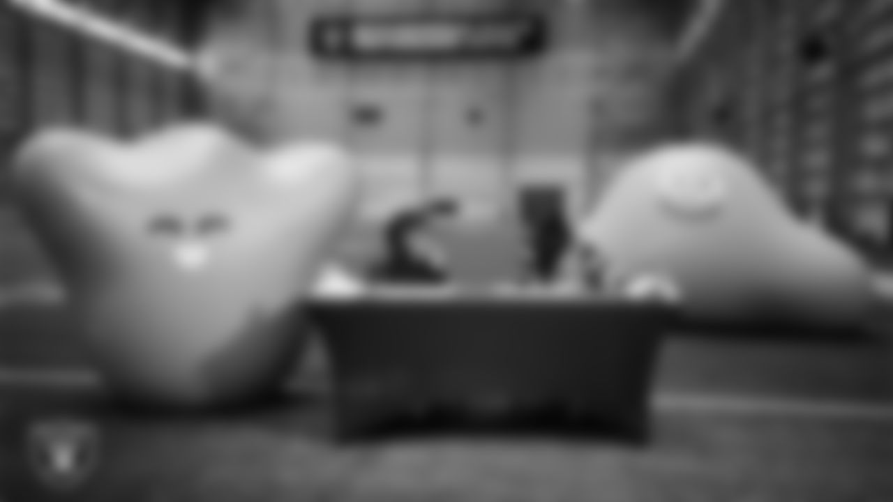 Las Vegas Raiders President Sandra Douglass Morgan designs custom shoes for My Cause My Cleats with Intermountain Children's Health patient Evelyn at Intermountain Health Performance Center.