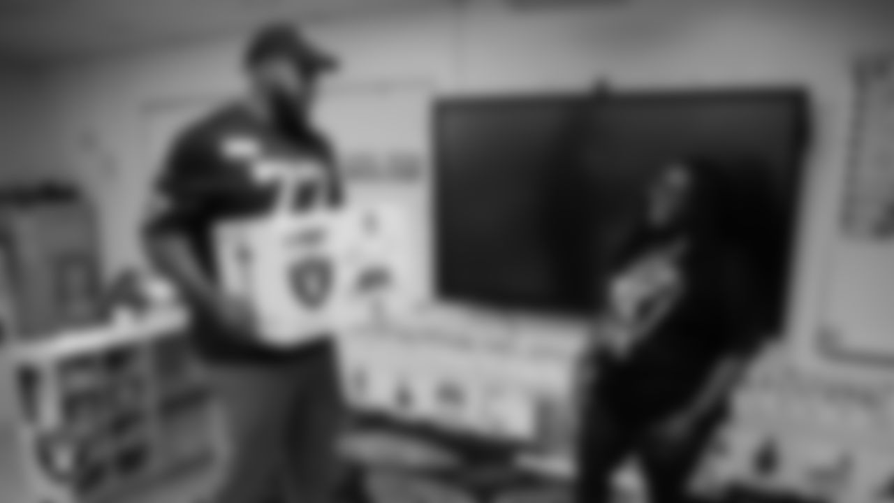 Las Vegas Raiders tackle Thayer Munford Jr. (77) delivers a classroom gift box to celebrate Teacher Appreciation Week at Matt Kelly Elementary School.