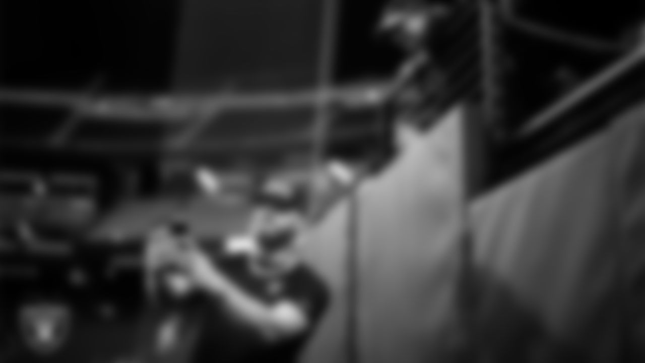 Las Vegas Raiders defensive end Maxx Crosby (98) takes a selfie with a fan before the regular season home game against the Kansas City Chiefs at Allegiant Stadium.