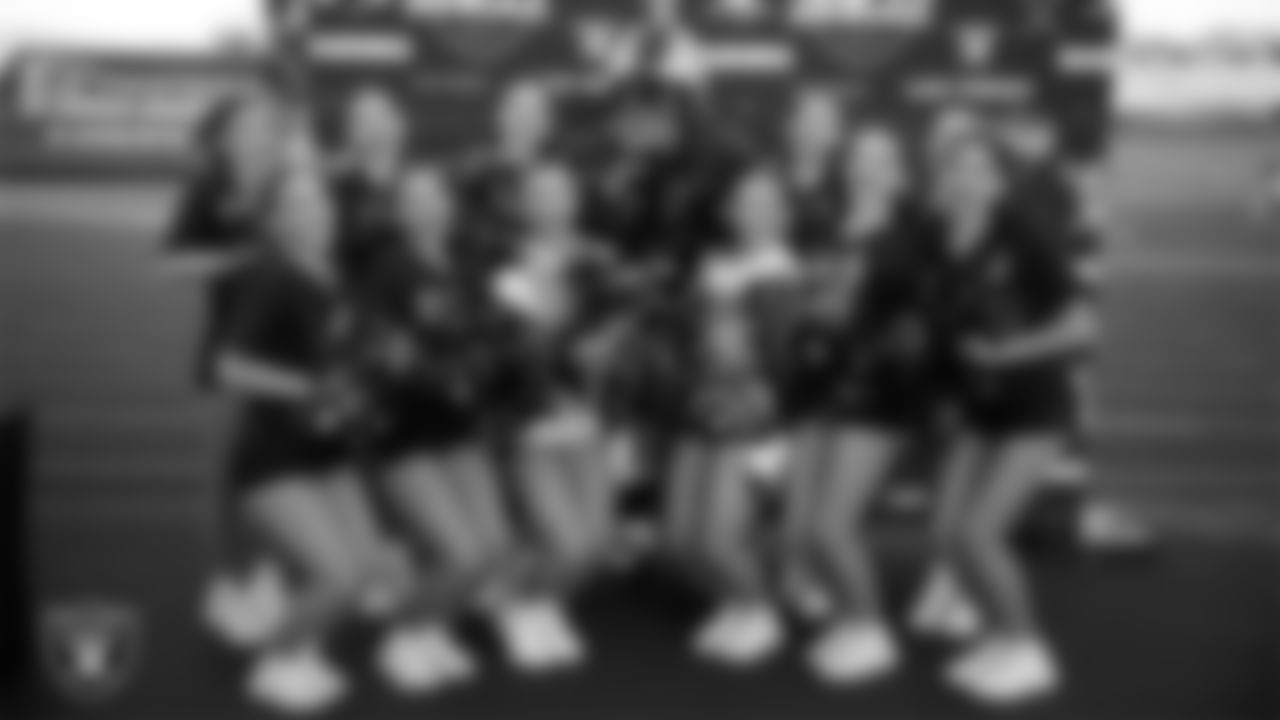 Raider Rusher poses with the Foothill High School dance team before the Las Vegas Raiders' Football Showcase game at Foothill High School.