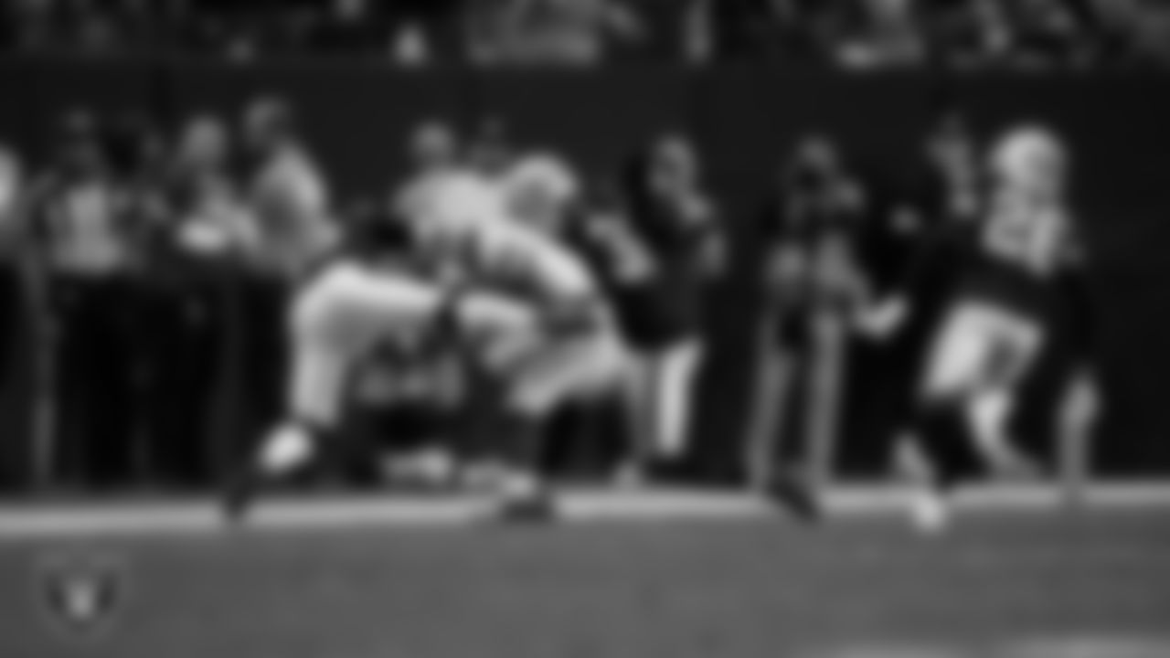 Las Vegas Raiders linebacker Jamal Adams (33) and safety Lonnie Johnson Jr. (32) make a tackle during the regular season home game against the New York Giants at Allegiant Stadium.