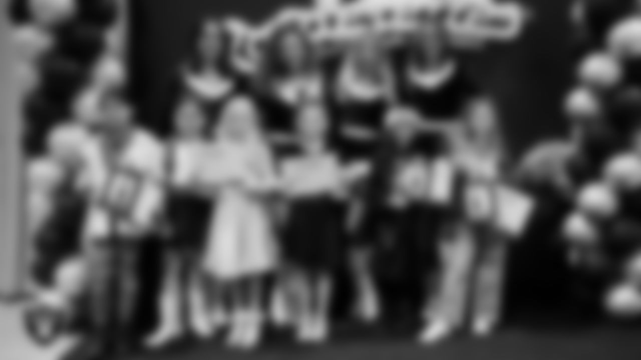 Raiderettes pose for a photo with Junior Raiderettes during the Junior Raiderettes Banquet at The Studio.