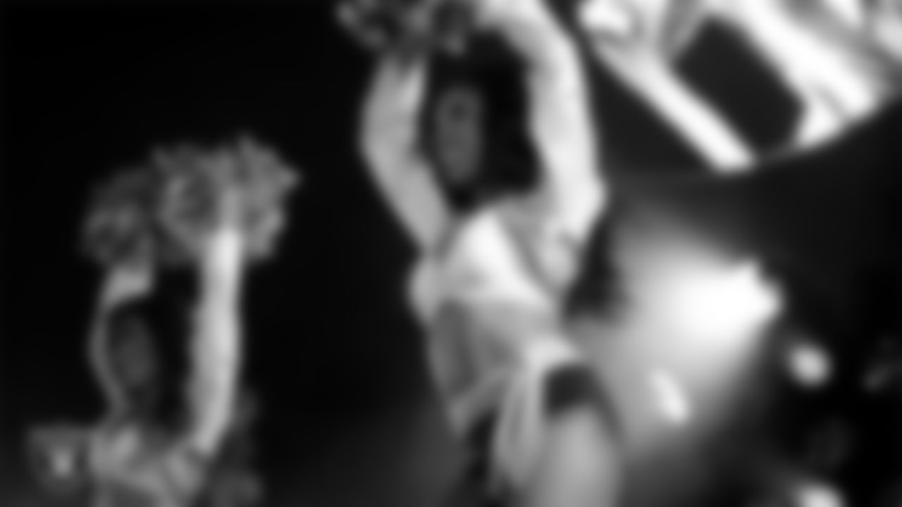 Raiderette Bria performs with Rapper Nelly at halftime during the regular season home game against the Dallas Cowboys at Allegiant Stadium.