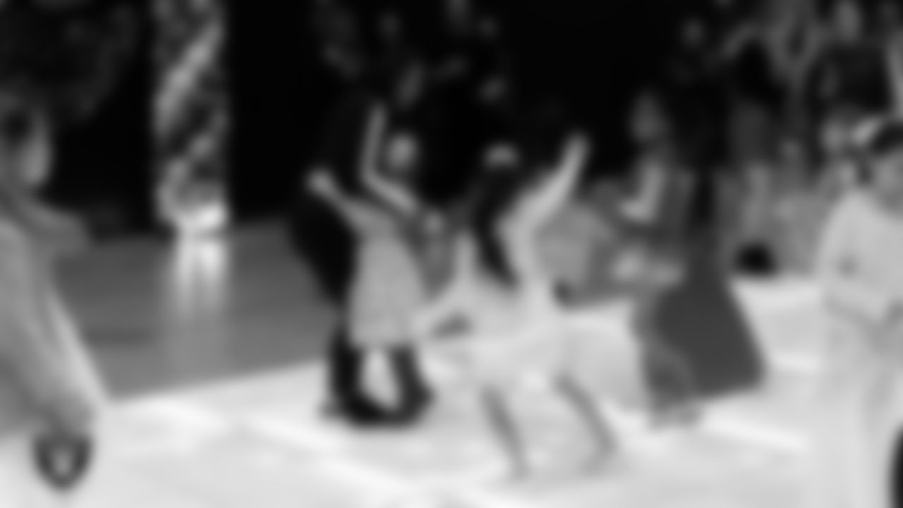 Raiderette Ashtin dances with attendees during the Valentine's Day Dance at The Studio.