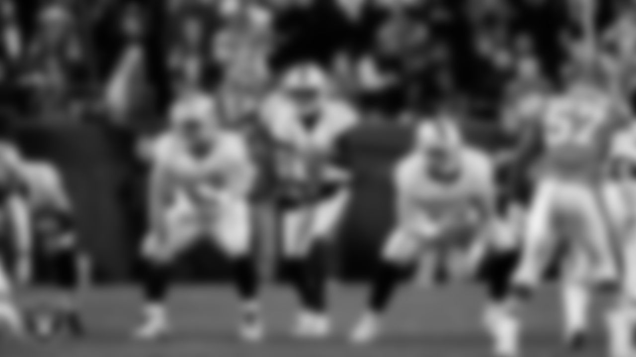 Las Vegas Raiders quarterback Geno Smith (7) receives the snap during the regular season away game against the Denver Broncos at Empower Field at Mile High.