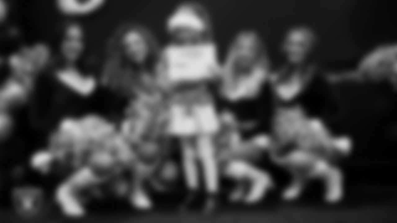 Raiderettes pose for a photo with a Junior Raiderette during the Junior Raiderettes Banquet at The Studio.