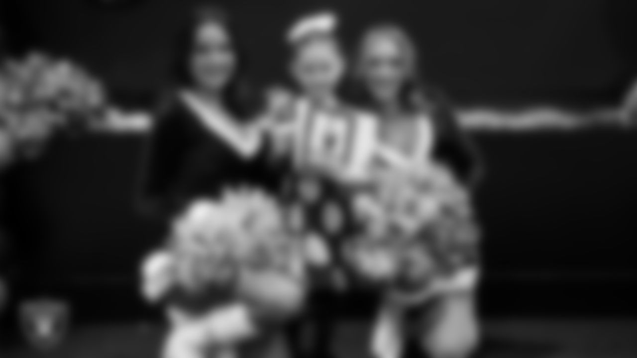 Raiderettes pose for a photo with a Junior Raiderette during the Junior Raiderettes Banquet at The Studio.