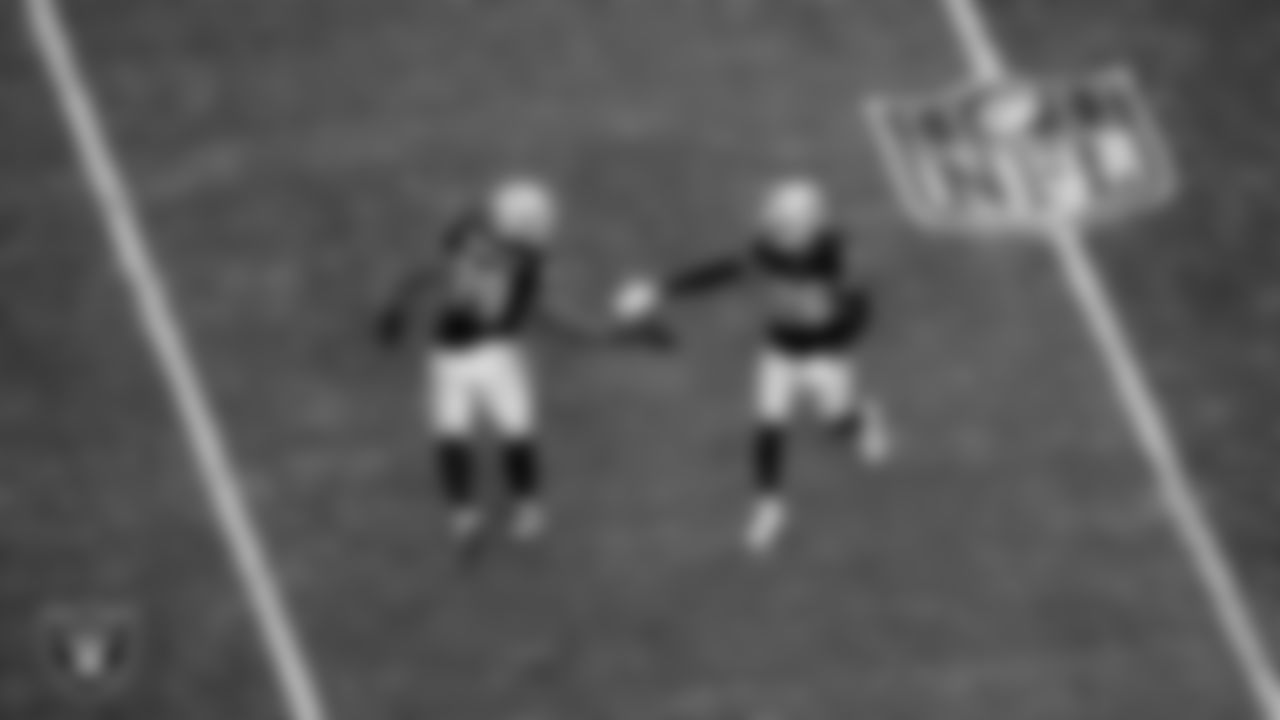 Las Vegas Raiders defensive tackle Thomas Booker IV (99) and cornerback Dairen Porter (26) during the regular season home game against the Denver Broncos at Allegiant Stadium.