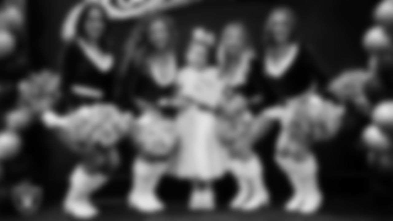 Raiderettes pose for a photo with a Junior Raiderette during the Junior Raiderettes Banquet at The Studio.