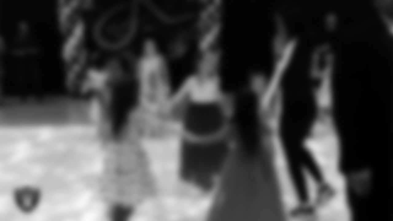 Raiderette Reagan dances with attendees during the Valentine's Day Dance at The Studio.