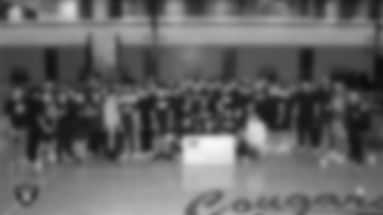 Spanish Springs High School football coach Rob Hummel poses for a photo with his team after being named the Tom Flores Coach of the Year at Spanish Springs High School.