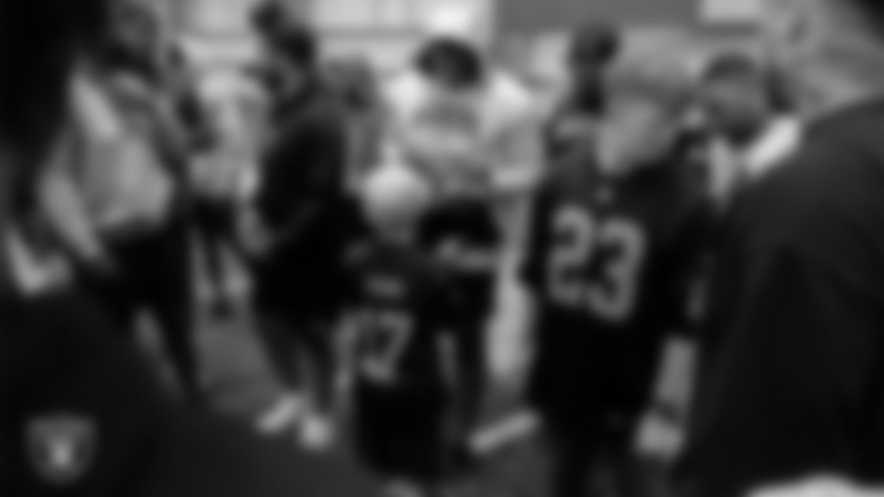 Clay Charlson from the Make-A-Wish Foundation gets his jersey signed by Las Vegas Raiders defensive end Tyree Wilson (9) during a visit to Intermountain Health Performance Center.