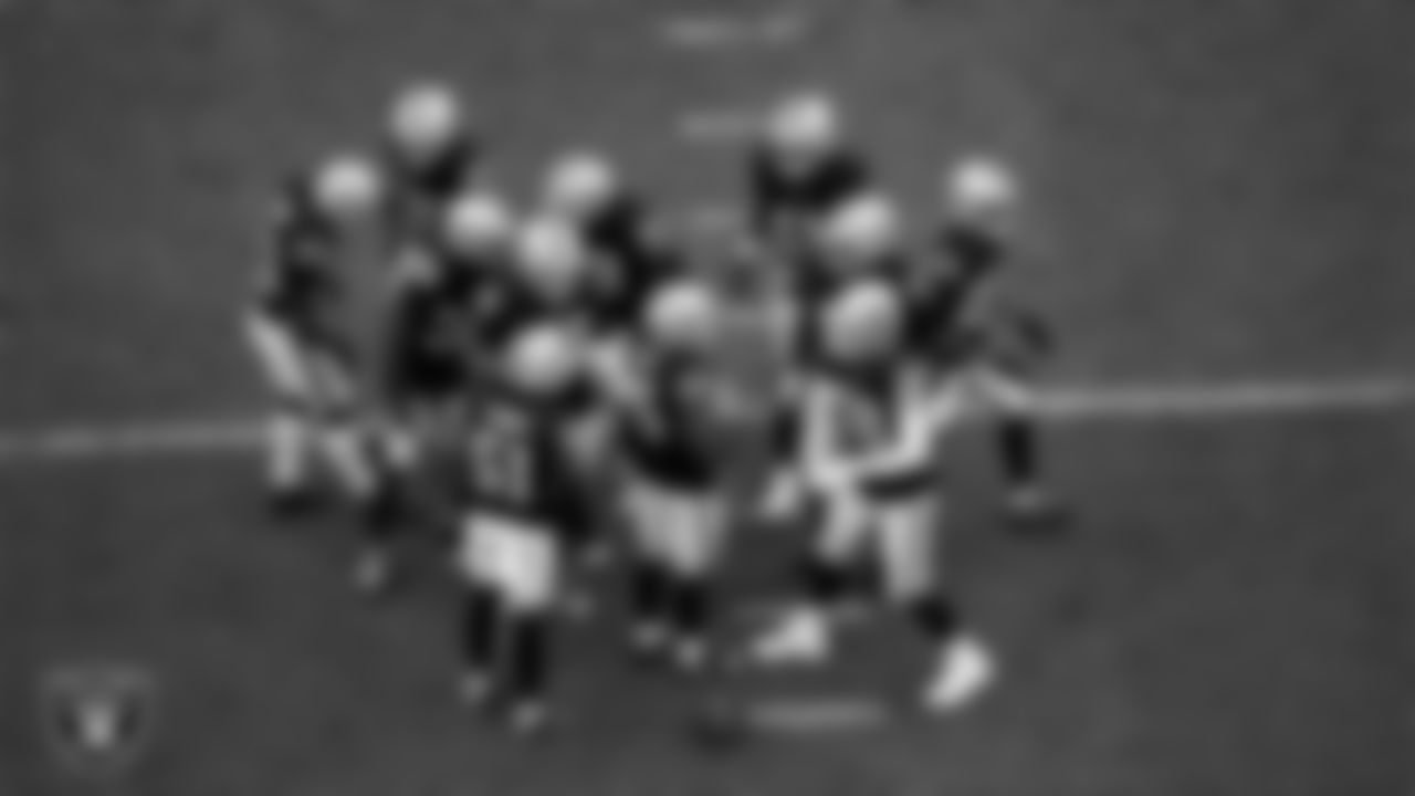 The Las Vegas Raiders defense huddles during the regular season home game against the Tennessee Titans at Allegiant Stadium.