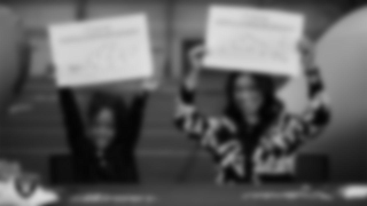 Las Vegas Raiders President Sandra Douglass Morgan and  Intermountain Children's Health patient Evelyn show off their My Cause My Cleats custom shoes design at Intermountain Health Performance Center.