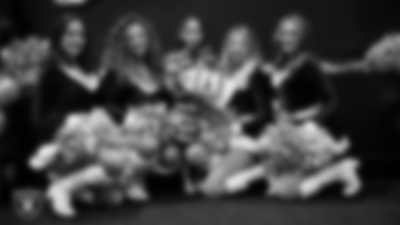 Raiderettes pose for a photo with a Junior Raiderette during the Junior Raiderettes Banquet at The Studio.