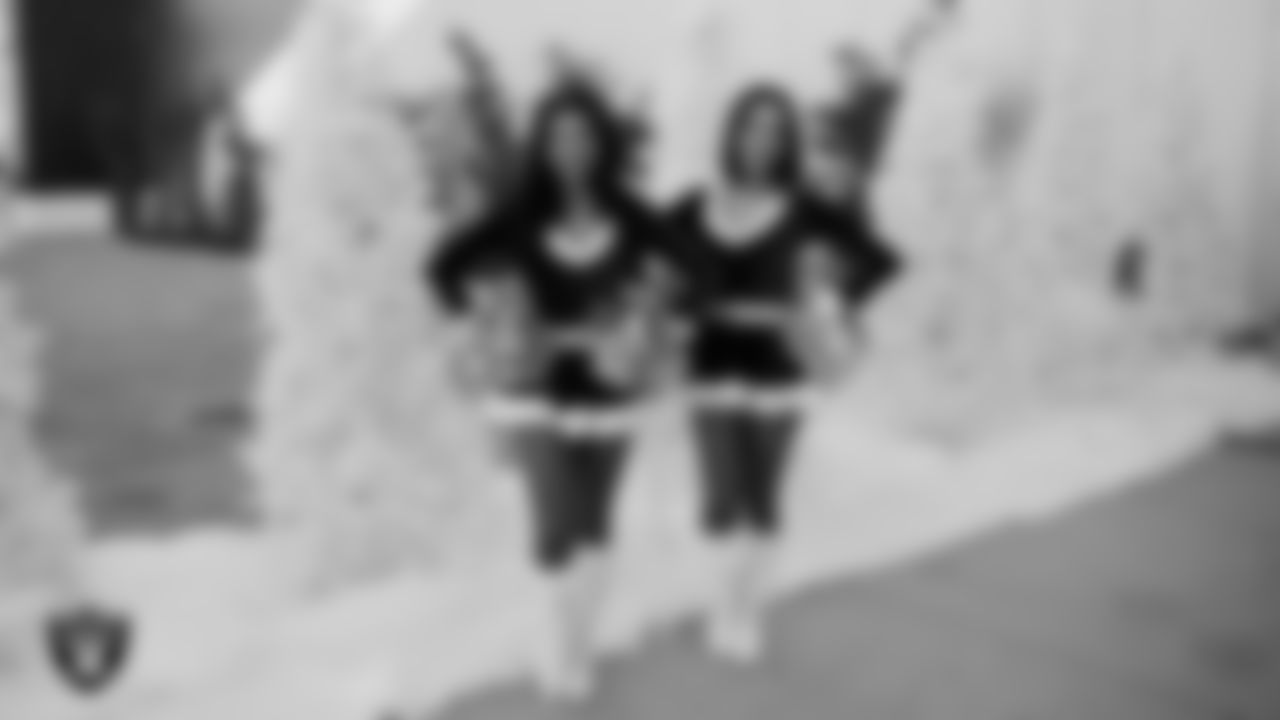 Raiderettes Kylee and Kylie welcome students to a Raiders Youth Holiday Party at Intermountain Health Performance Center.