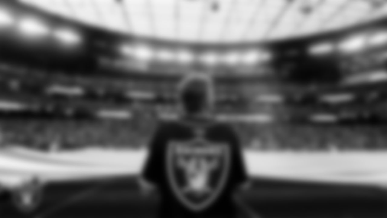 The American flag is displayed by Personal Seat License (PSL) holders on the field during the national anthem before the Las Vegas Raiders' regular season home game against the Cleveland Browns at Allegiant Stadium.