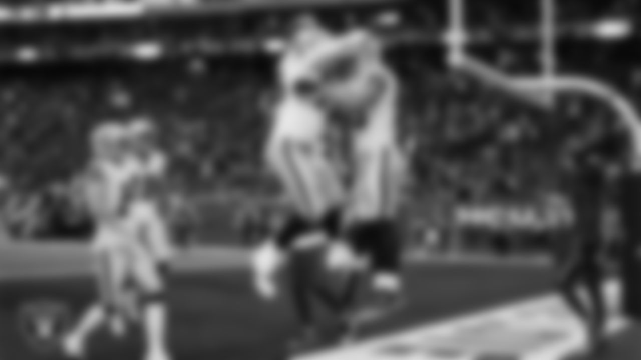Las Vegas Raiders tight end Brock Bowers (89) celebrates with guard Caleb Rogers (76) after making a 7-yard touchdown catch during the regular season away game against the Houston Texans at NRG Stadium.